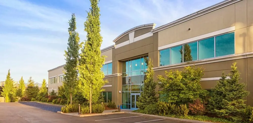 An office building with trees in front of it.