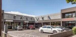 A parking lot with cars parked in front of a store.