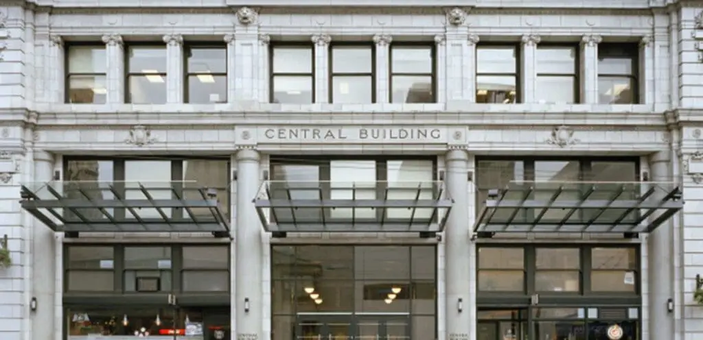 The entrance to a building with a sign that says centennial building.