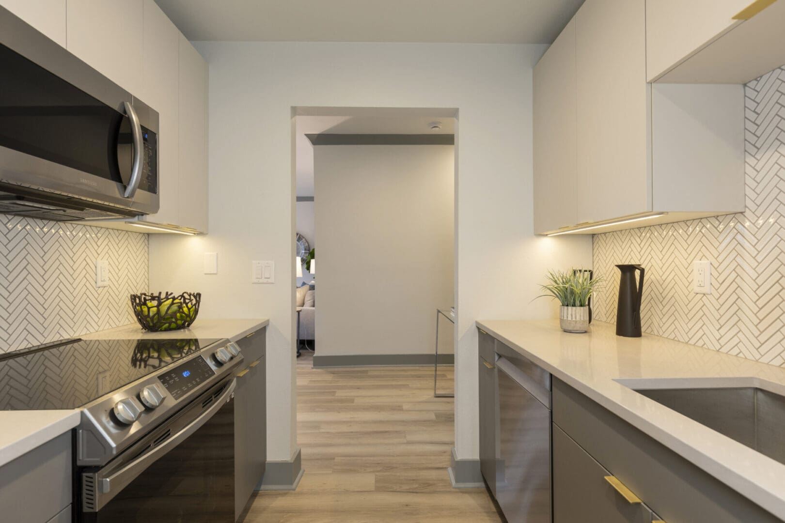 A kitchen with stainless steel appliances and a microwave.